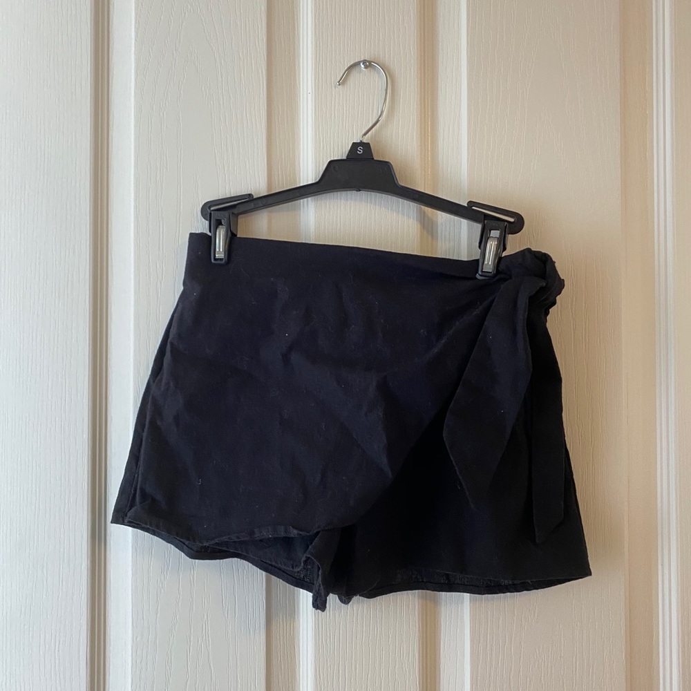Black shorts with skirt overlay and side tie